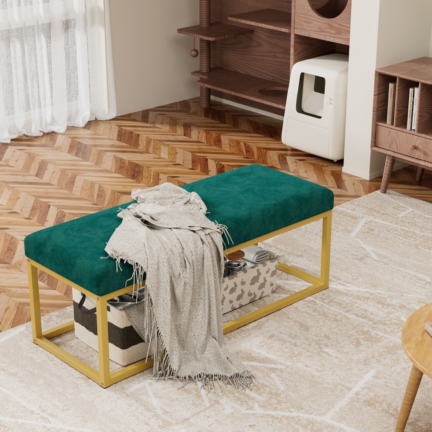 Green upholstered bench with gold frame in a room with wooden flooring and shelves.