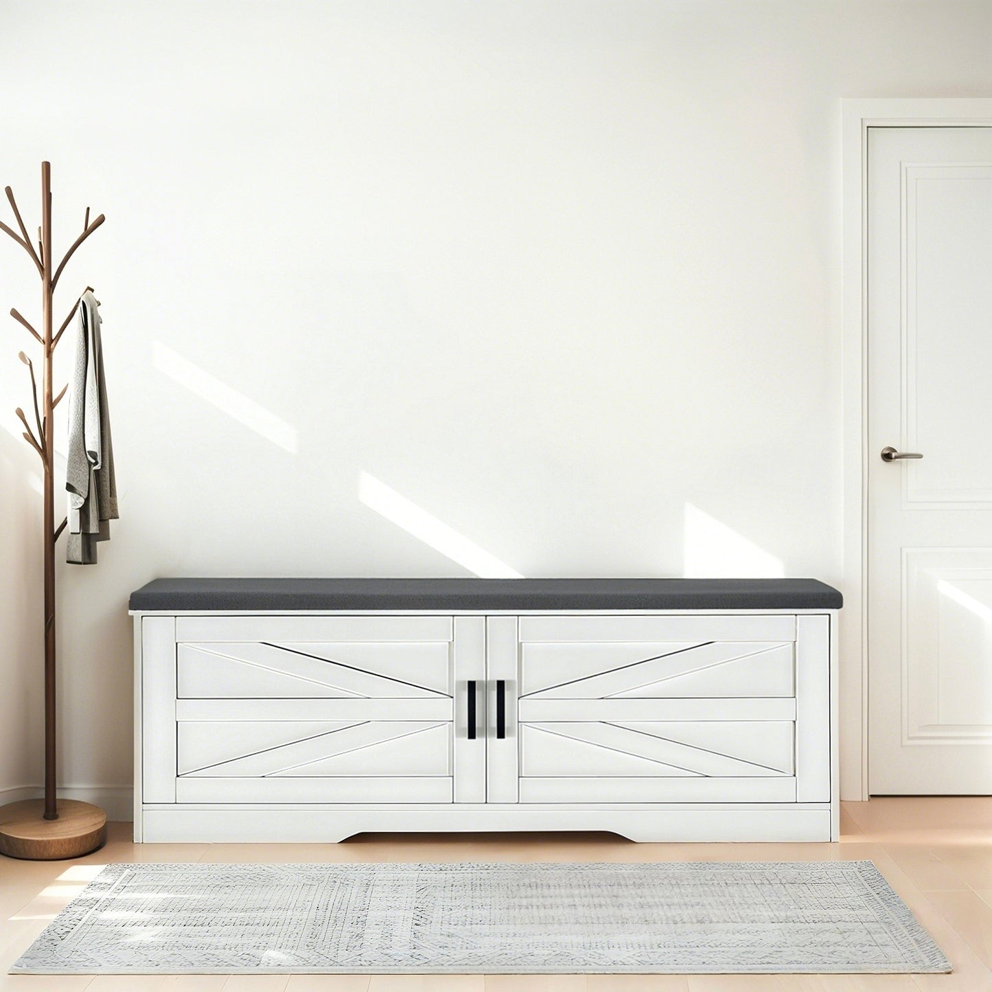 White storage bench with black top in a room with a coat rack and door.