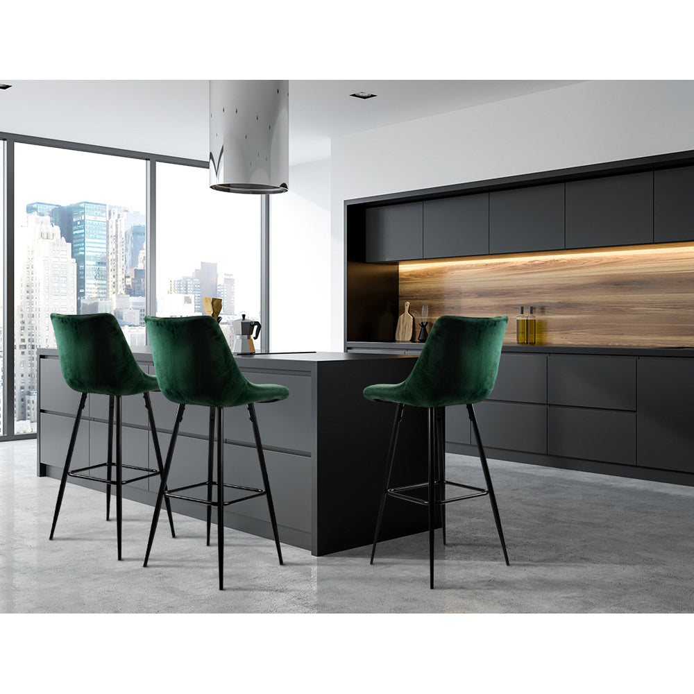 Modern kitchen with green bar stools and a cityscape view