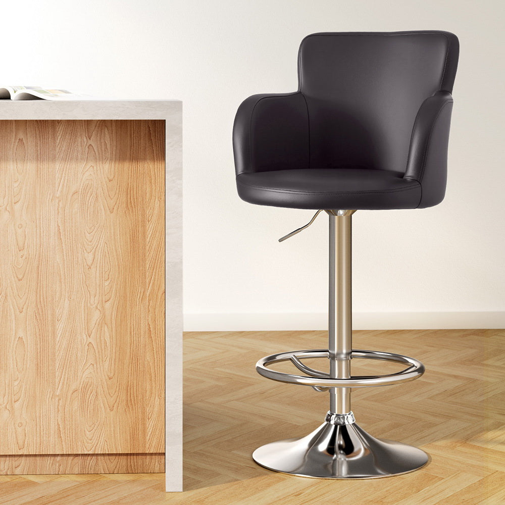 Stylish NORDIQE Dramos Swivel Bar Stool in brown faux leather with a sleek chrome base — perfect for modern interiors.