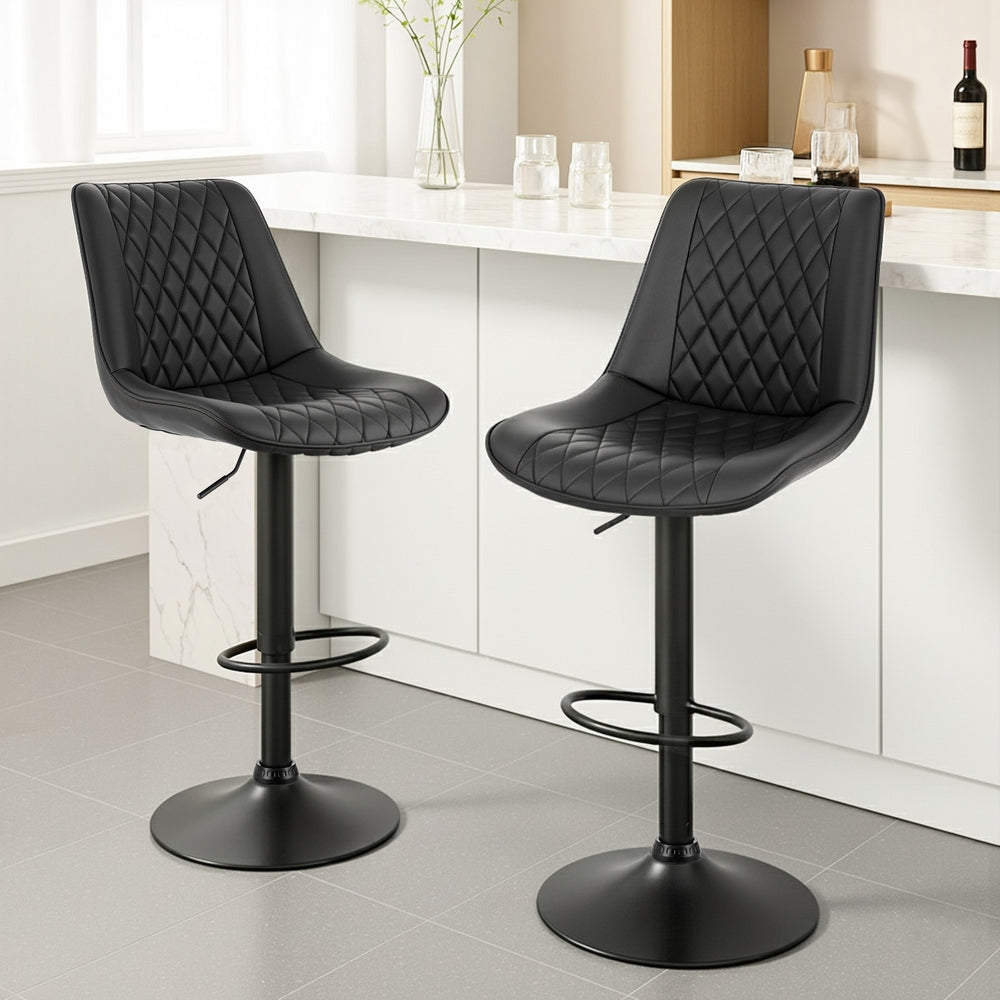 Elegant NORDIQE Lorena Bar Stools in black faux leather featuring a stylish diamond quilted design—perfect for modern kitchens.