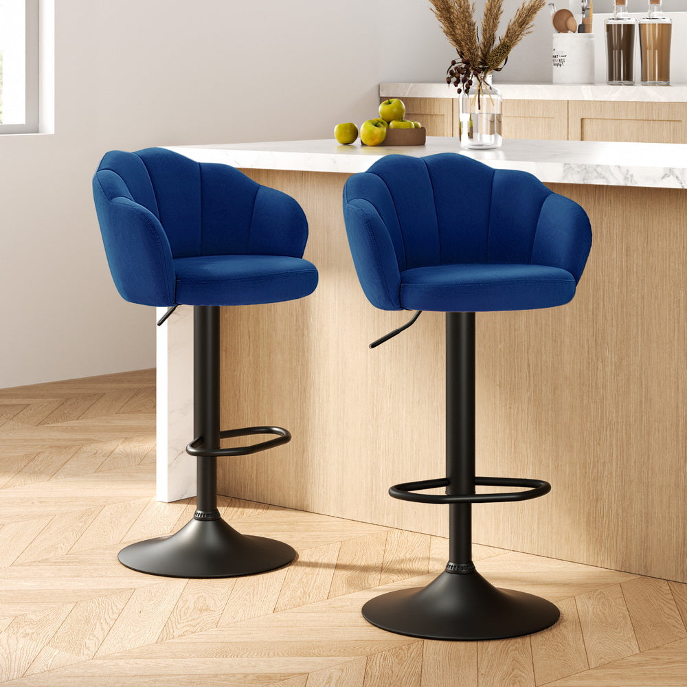 Two blue bar stools with black bases in a kitchen setting.