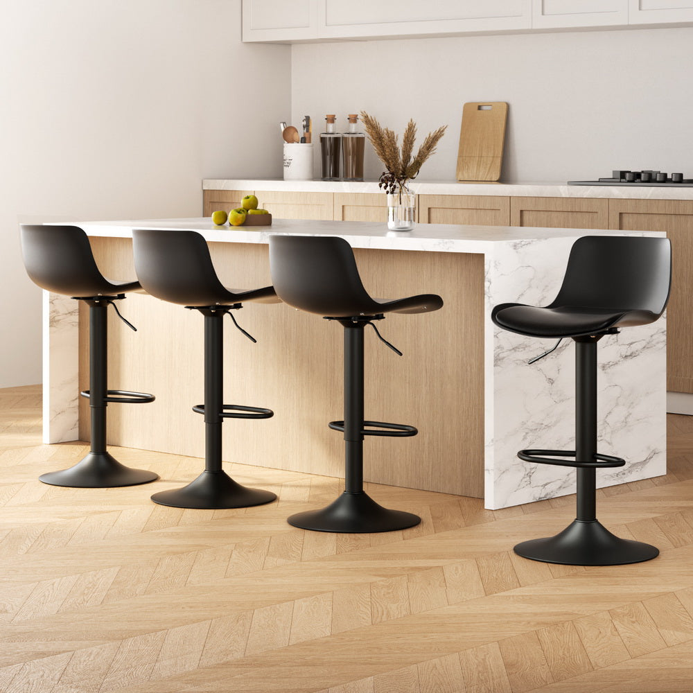 Sleek NORDIQE Fynn Bar Stools in black featuring a modern design with smooth curves and a sturdy base, perfect for any kitchen.