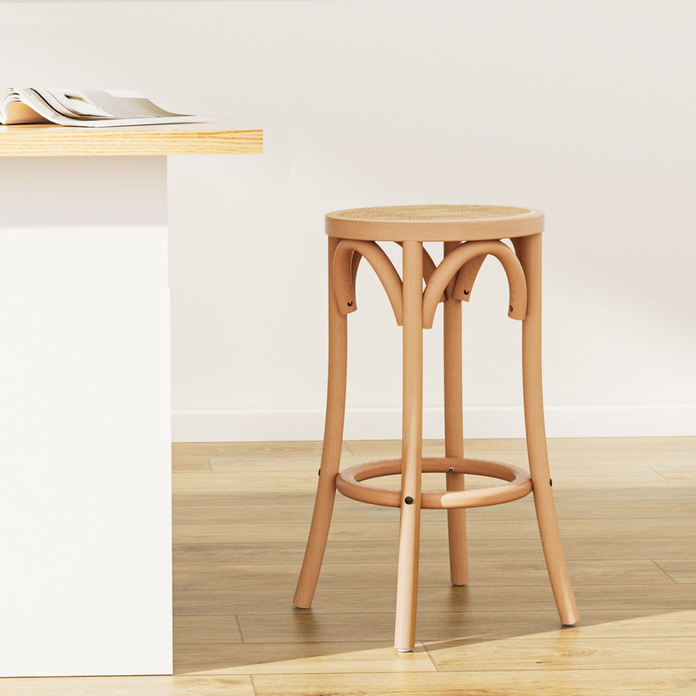 Wooden bar stool in a minimalistic room with a table and newspaper.