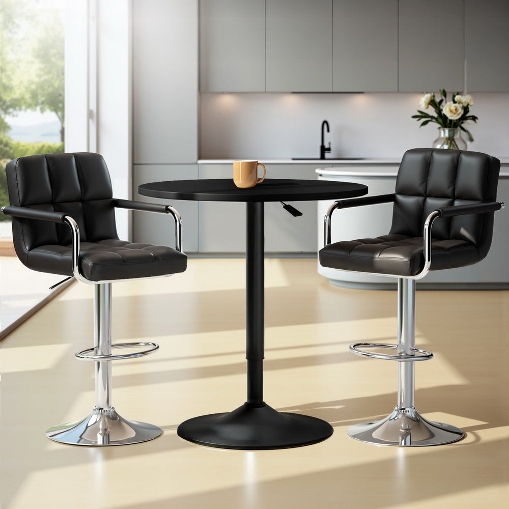 Elyrius Bar Table Set by NORDIQE features a sleek black table with modern chrome stools upholstered in soft black leather.
