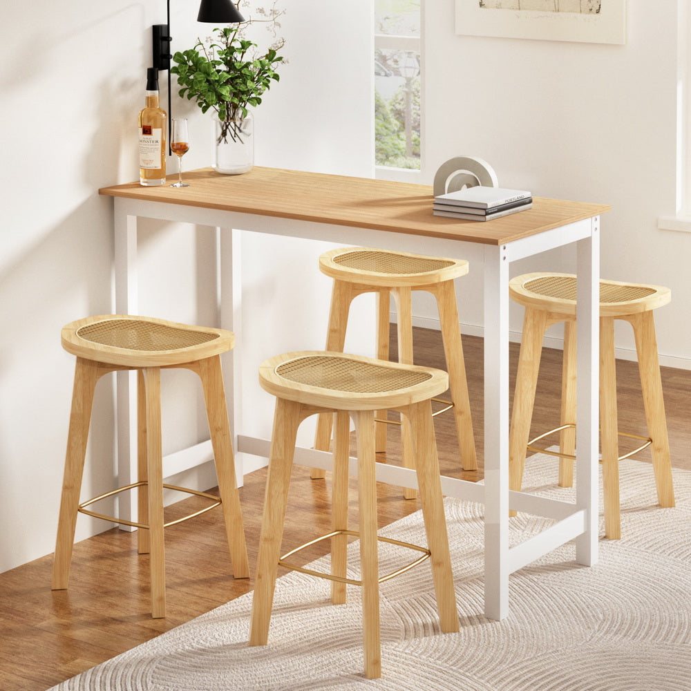 Stylish Braldor Bar Table Set by NORDIQE featuring beige rattan stools and a sleek white frame, perfect for modern spaces.