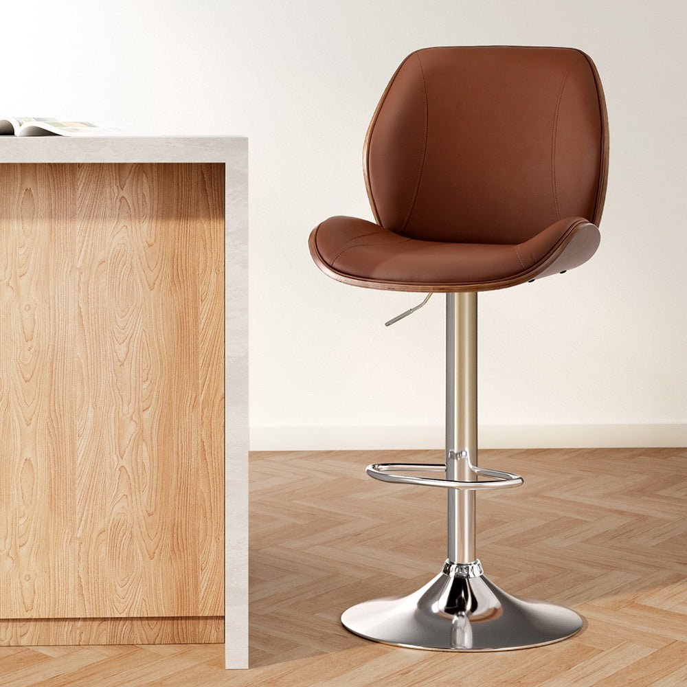 Stylish NORDIQE Korvath Bar Stool in brown faux leather with a sleek chrome base — perfect for modern kitchen spaces.