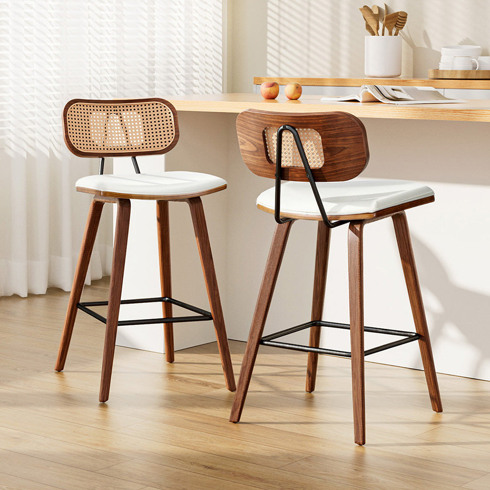 Stylish NORDIQE Camaca bar stools in beige with a wooden frame and woven backrest, enhancing modern kitchen decor.