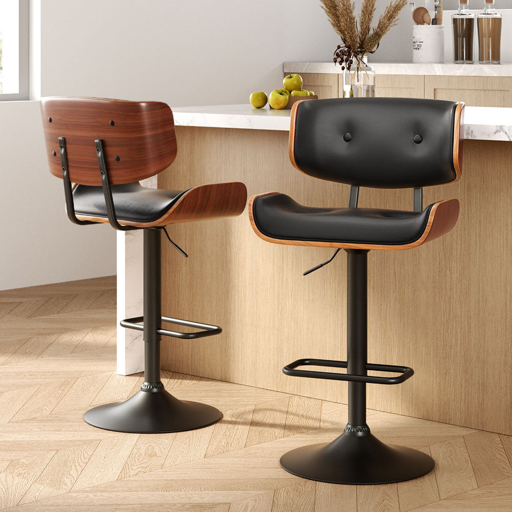 Sleek NORDIQE Cherry Premium Bar Stools in black with a stylish wood finish and comfortable padded seats — perfect for modern interiors.