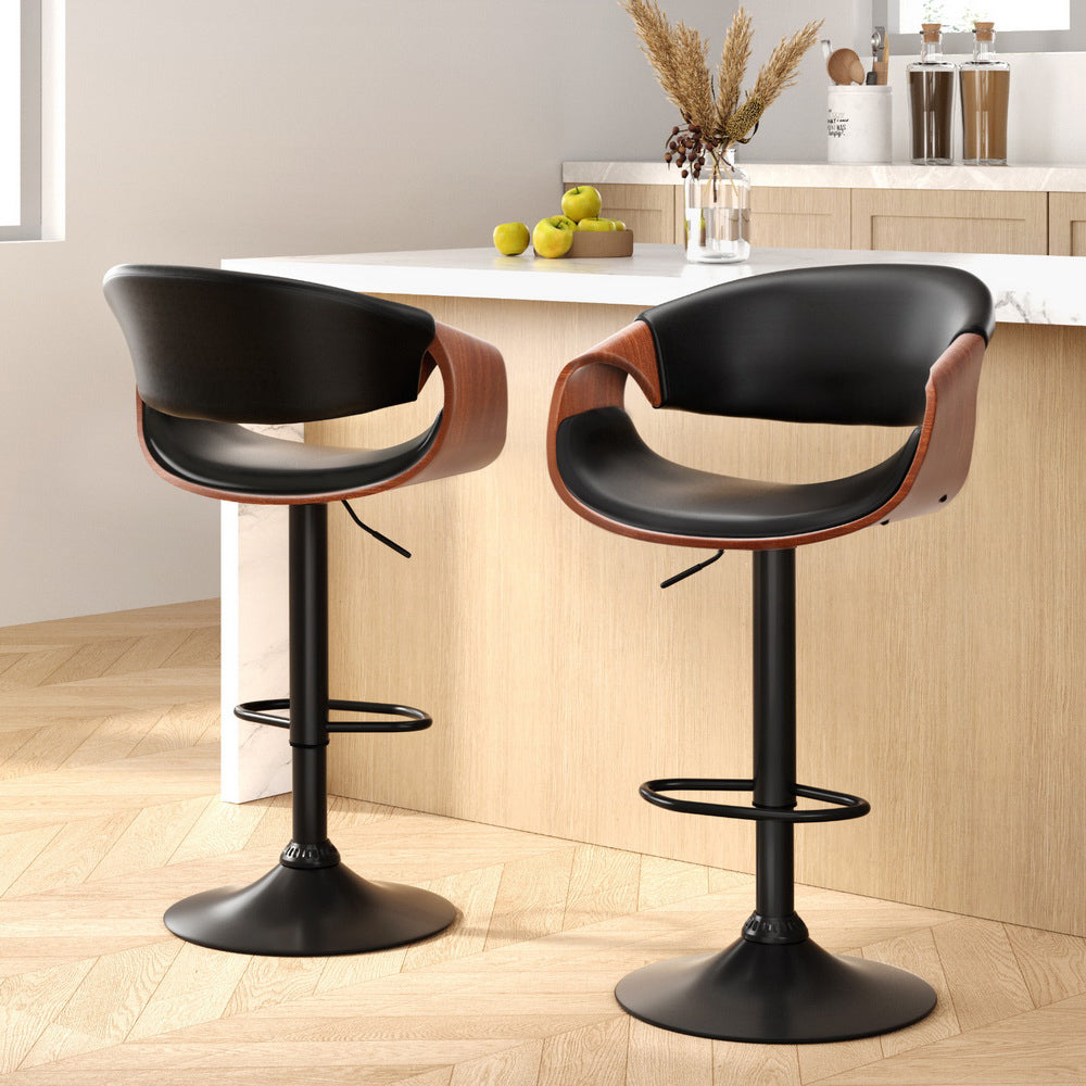 Two black and brown bar stools in a kitchen setting.