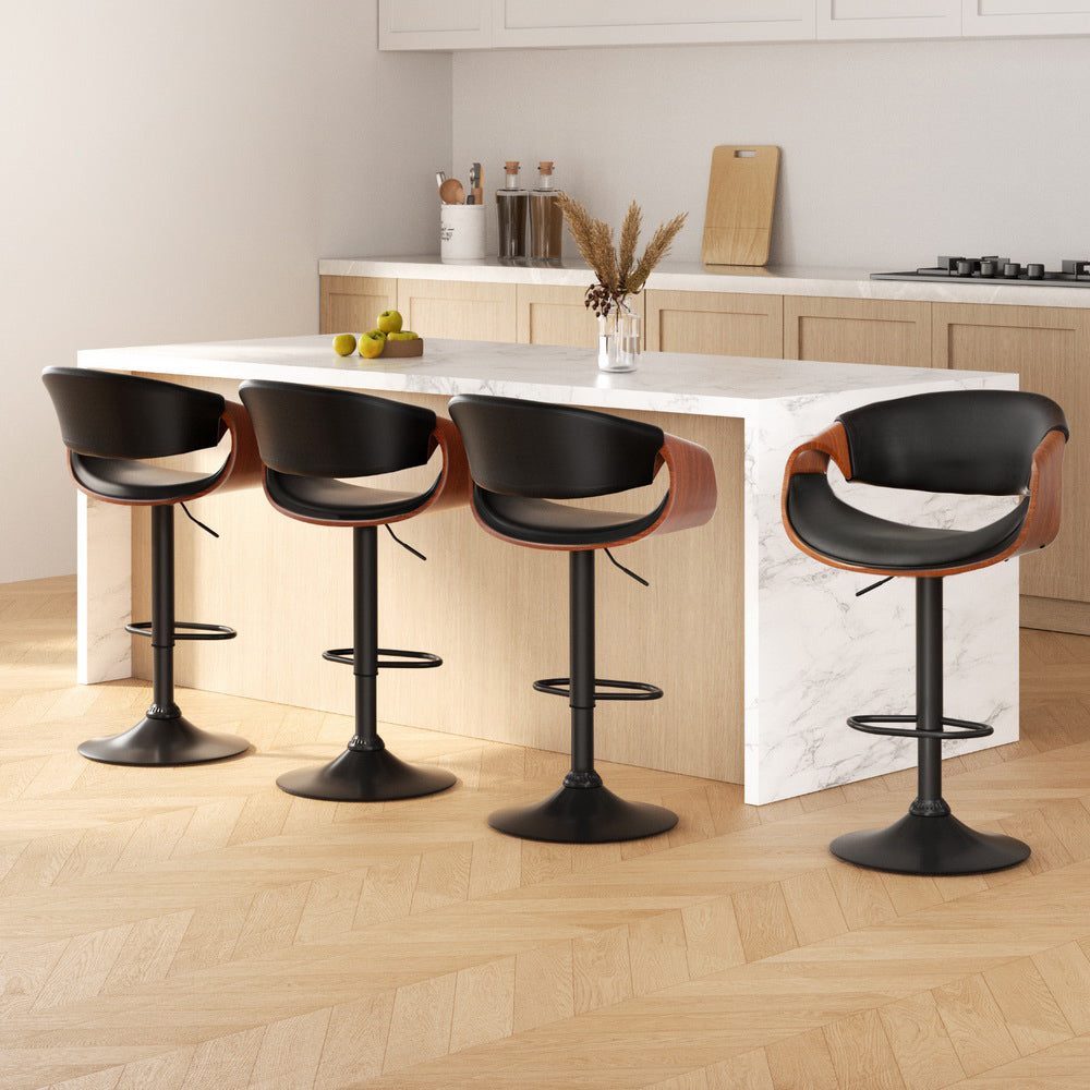 Sleek NORDIQE Lofir Bar Stools in black with warm wood accents — modern design featuring a comfortable curved seat.