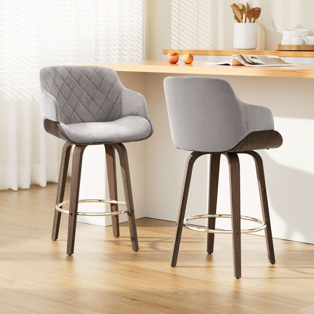 Two gray bar stools with wooden legs in a kitchen setting.