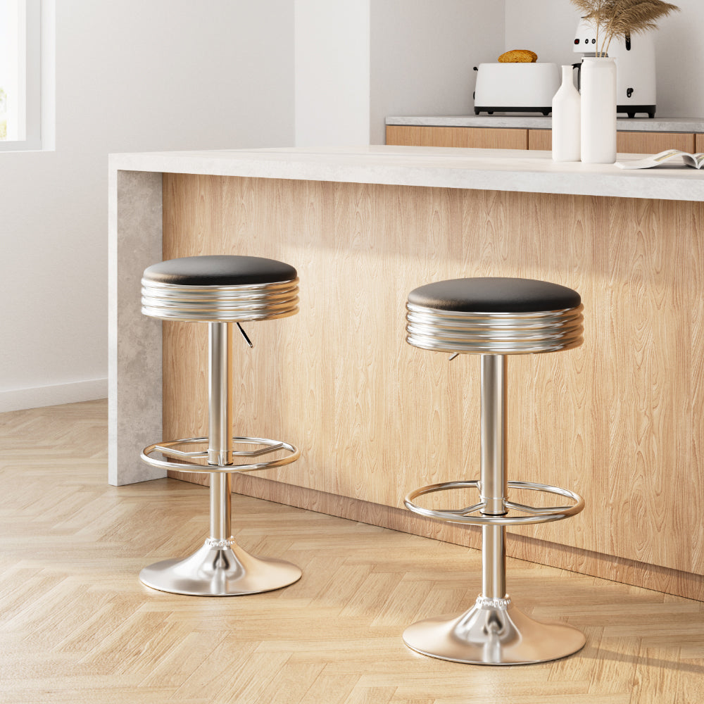 Sleek NORDIQE Anton Bar Stools in black with a polished chrome base — modern design featuring a comfortable padded seat.