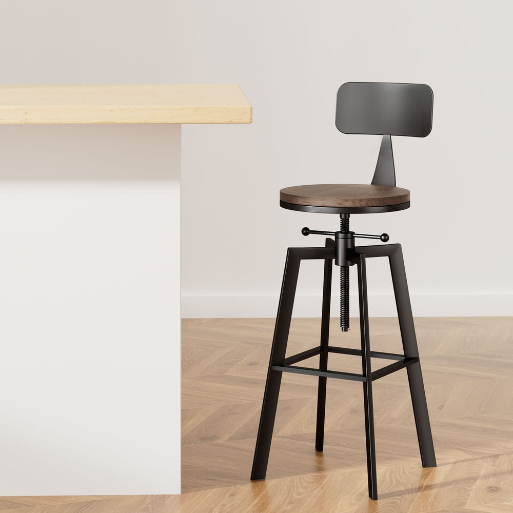 Bar stool with wooden seat and black metal frame in a minimalistic setting.
