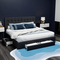 Modern bedroom with a black upholstered bed, white bedding, and nightstands.