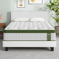 Mattress on a bed frame in a room with decor elements