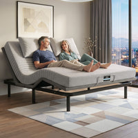 Couple sitting on a modern adjustable bed in a stylish living room.