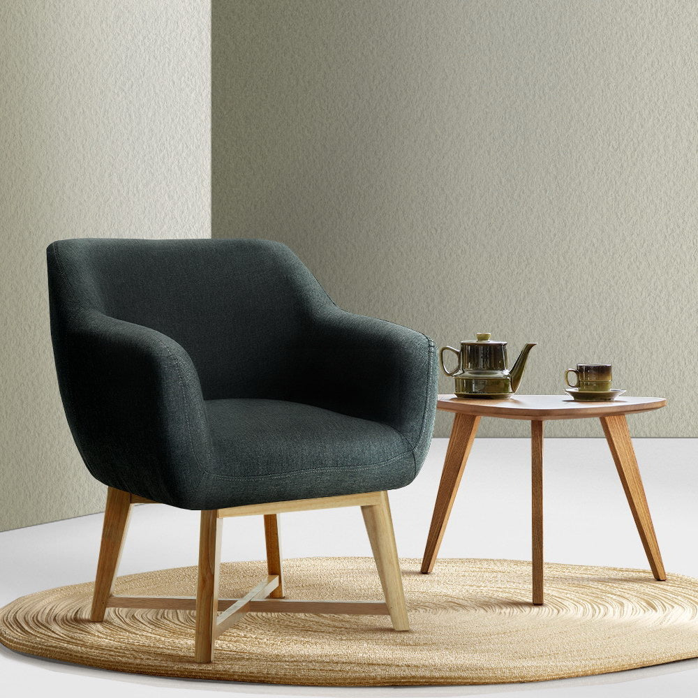 Charcoal fabric tub chair by NORDIQE with wooden legs and curved armrests