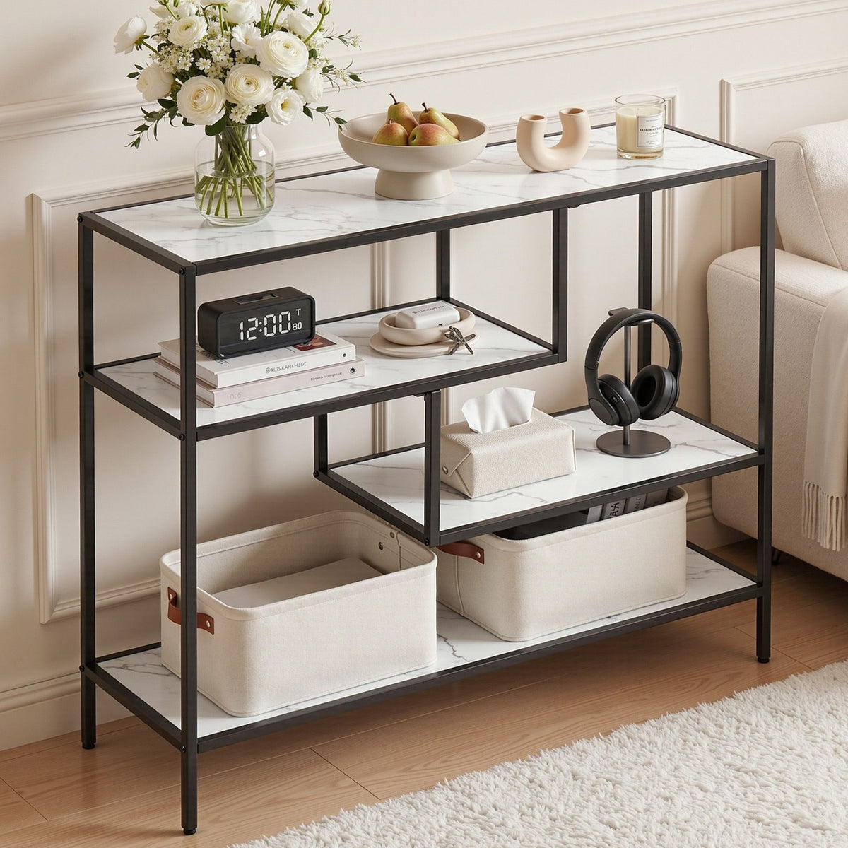 Black metal console table with white marble top in a living room setting.