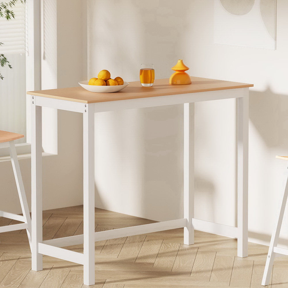NORDIQE Ari Bar Table in brown and white with a bowl of lemons and a glass of juice
