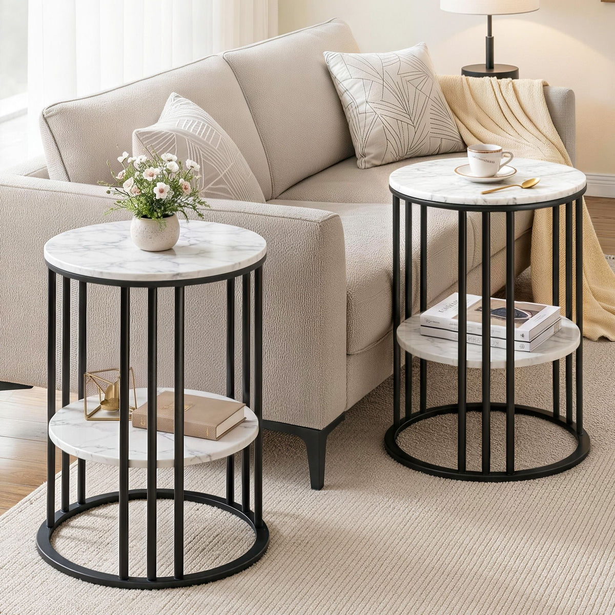 Two round side tables with marble tops and black metal frames in a living room setting.
