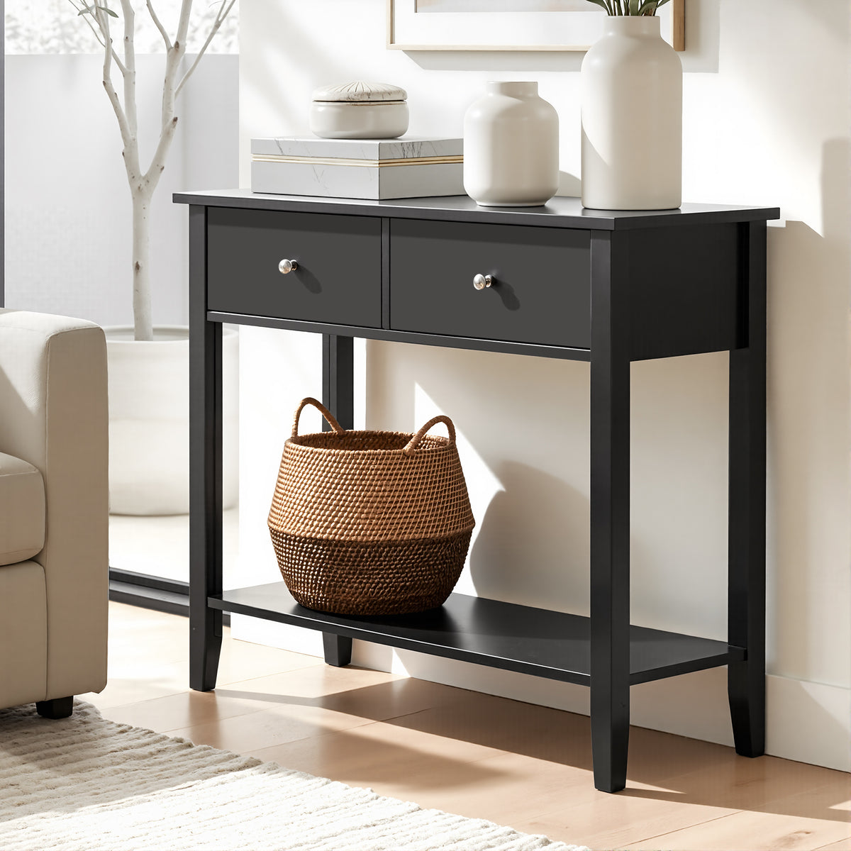 Black console table with two drawers and a shelf in a living room setting.