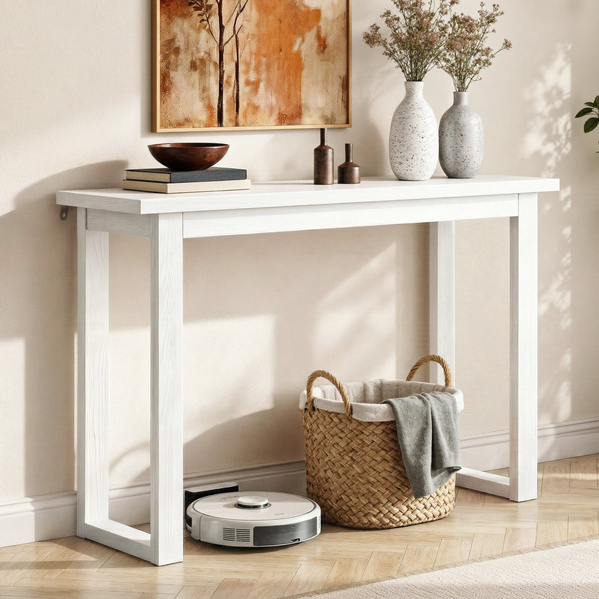 White console table with decorative items in a room setting