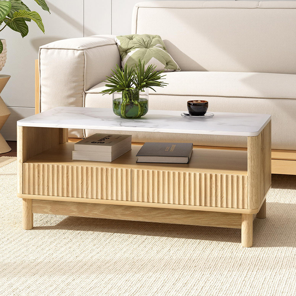 Wooden coffee table with marble top in a living room setting