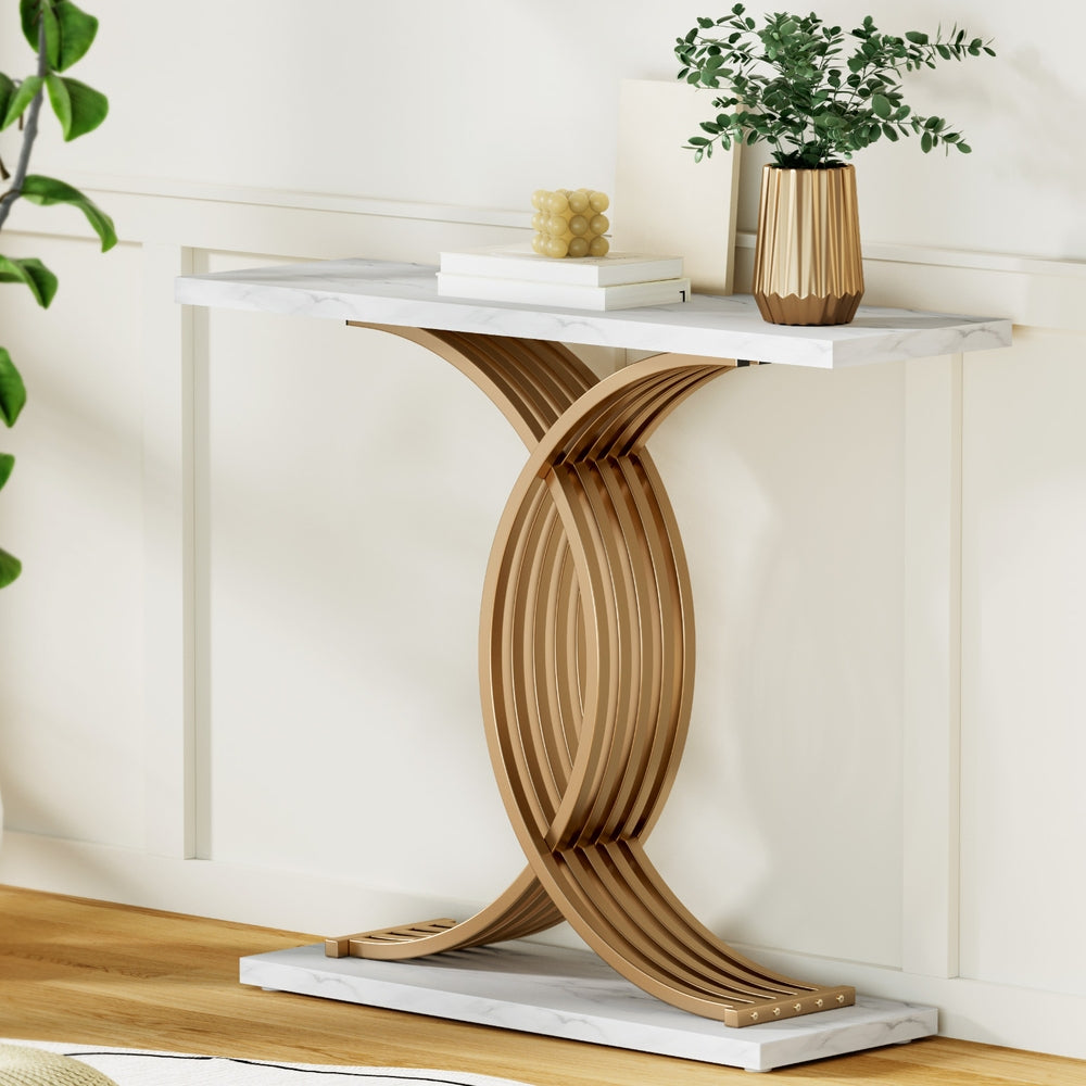 Modern console table with marble top and wooden base in a minimalistic room.