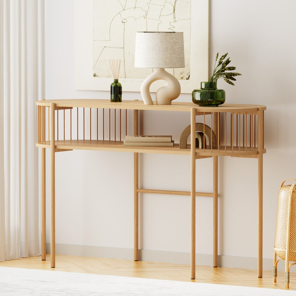 Wooden console table with decorative items against a white wall