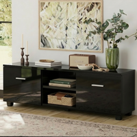 Black entertainment console with decorative items in a living room setting