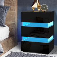 Black and blue nightstand with decorative items in a bedroom setting