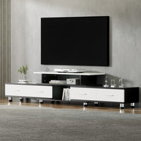 Modern TV stand with a black and white design in a living room setting.