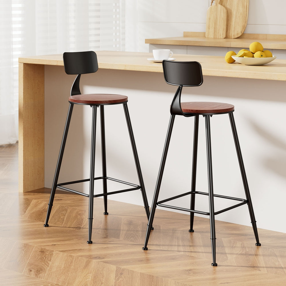 Two bar stools with black frames and red seats in a kitchen setting.