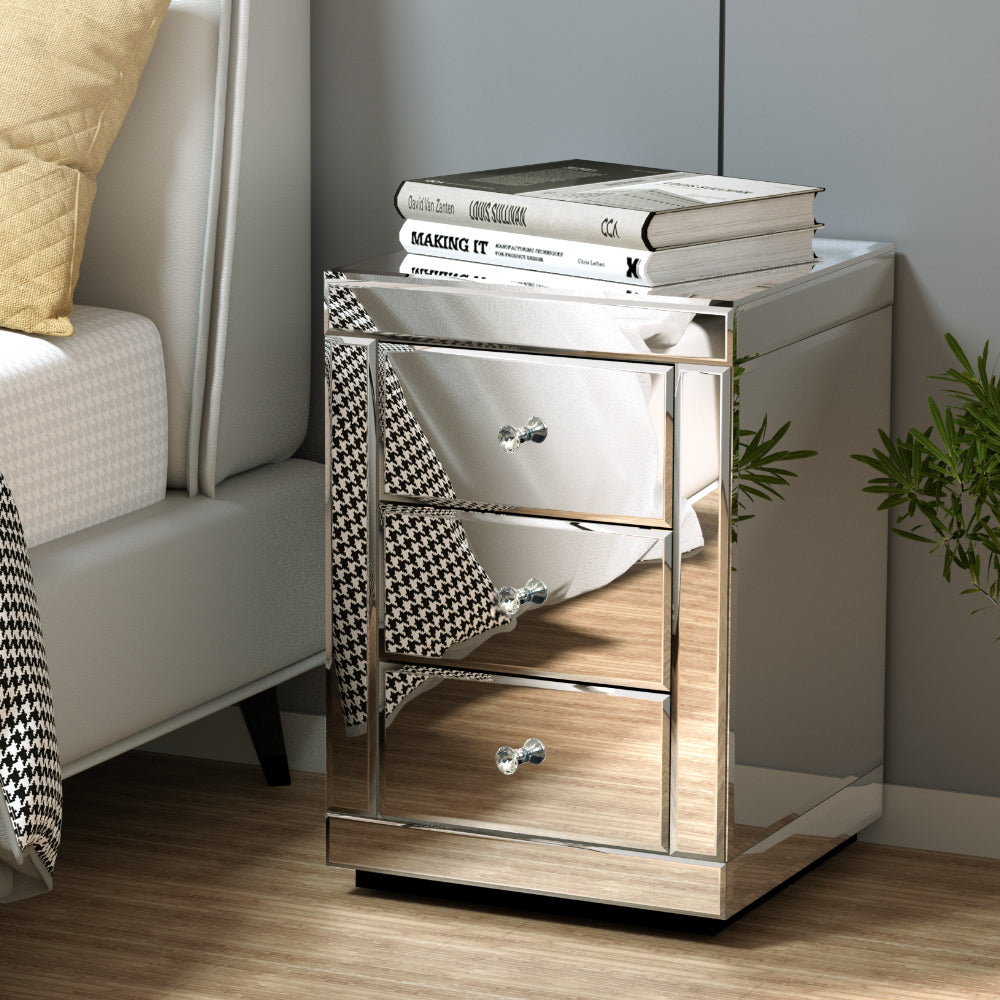 Mirrored nightstand with three drawers in a bedroom setting