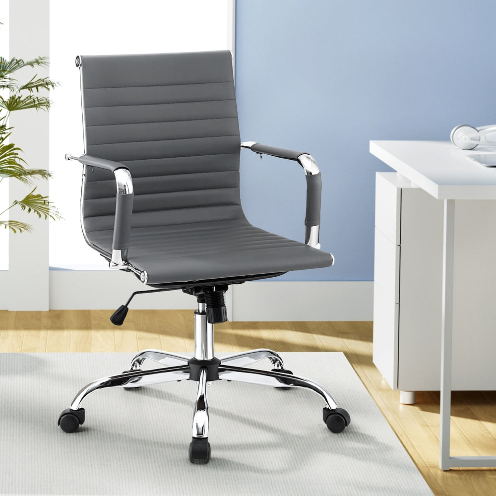 Sleek NORDIQE Nordak Office Chair in grey faux leather — ergonomic design with polished chrome accents and smooth rolling wheels