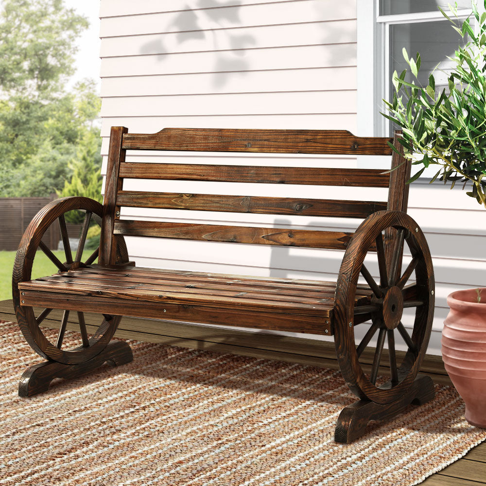 Benbi Outdoor Wagon Bench | Brown, rustic wooden garden bench with wagon wheel armrests, perfect for outdoor seating.