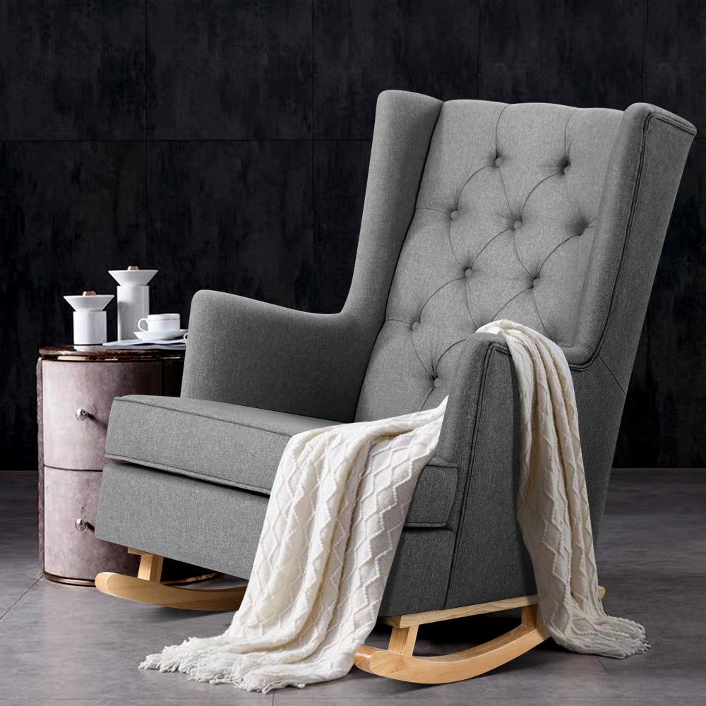 Grey linen fabric rocking chair by NORDIQE with tufted back and wooden base