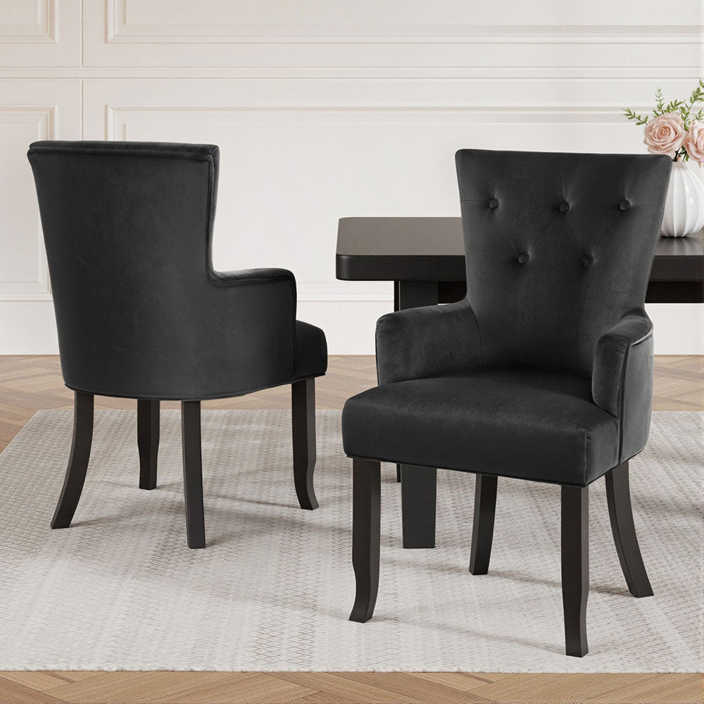 Elegant NORDIQE Cayes Dining Chairs in velvet black with button-tufted backs — a sophisticated addition to any dining space.