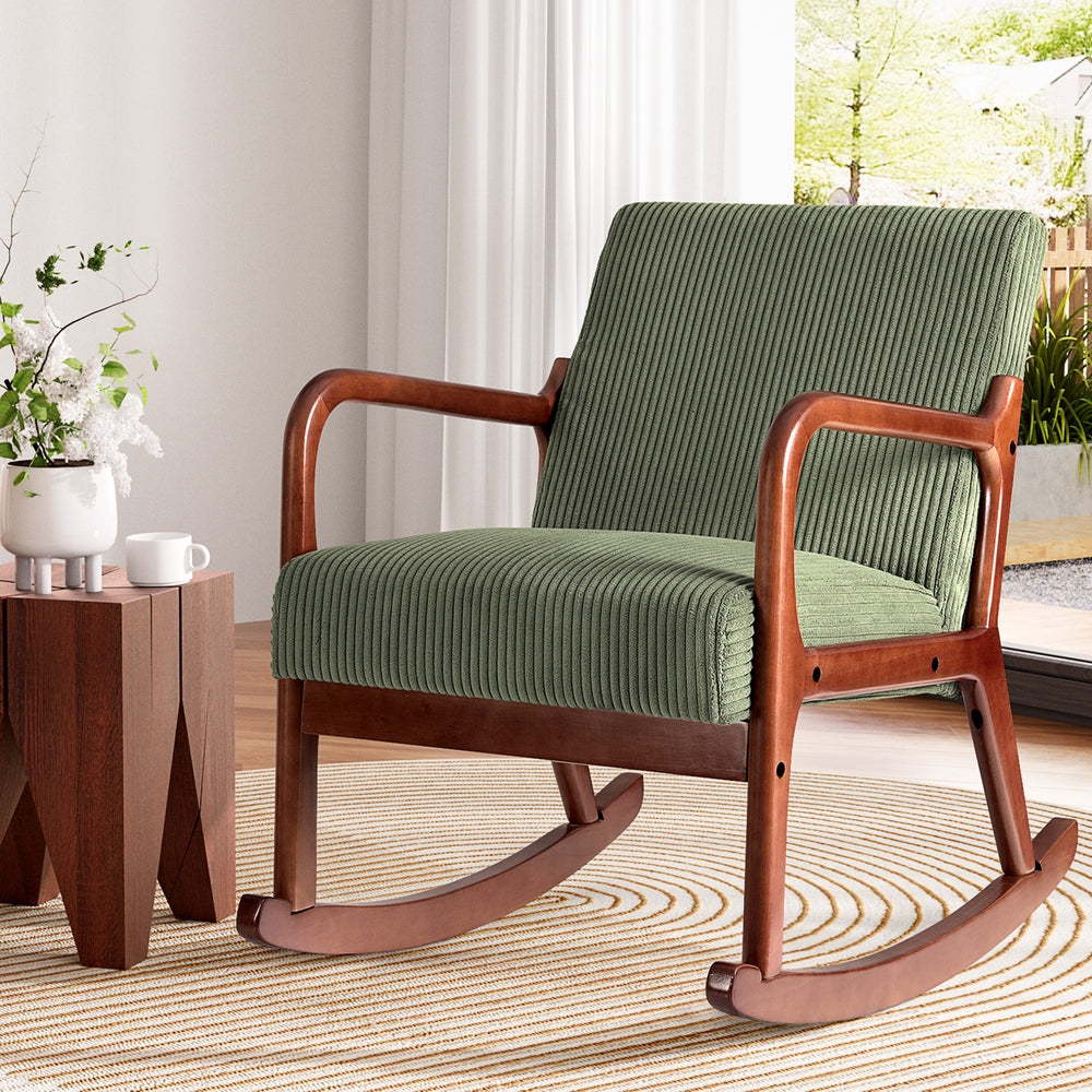 Green corduroy rocking armchair by NORDIQE with wooden frame and comfortable seating
