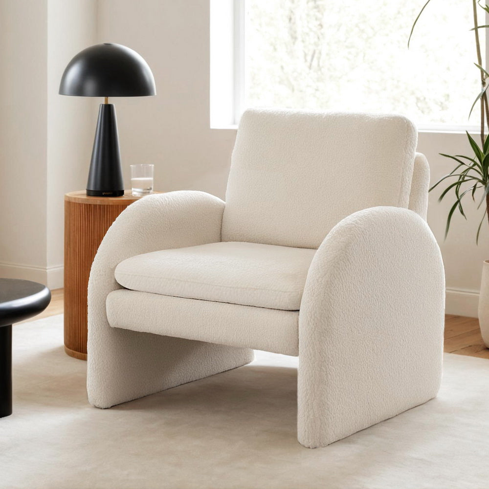 The Nexar Armchair by NORDIQE features a boucle white upholstery with soft, rounded edges — a cozy addition to modern interiors.
