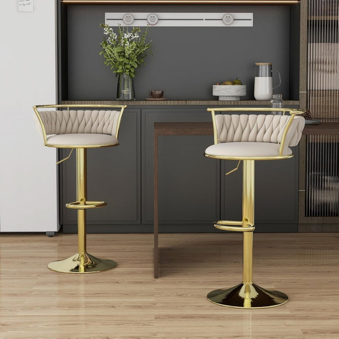 Elegant NORDIQE golden counter stools in ivory with a plush quilted seat and shiny metal base, enhancing modern interiors.