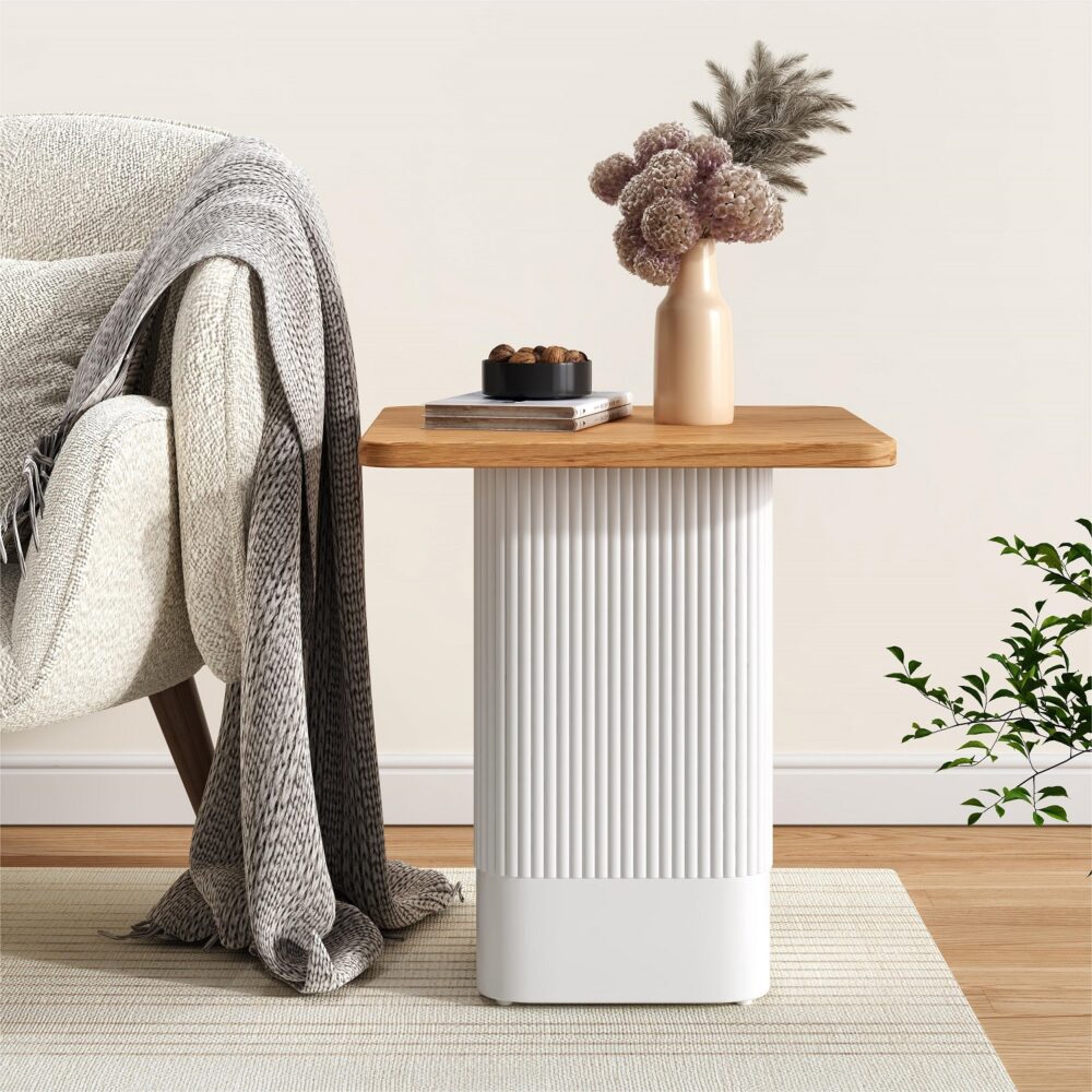 Modern side table with wooden top and white base in a living room setting.