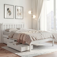 White bed with storage drawers in a bright bedroom with large windows.