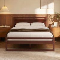 Wooden bed frame with white bedding in a bedroom setting