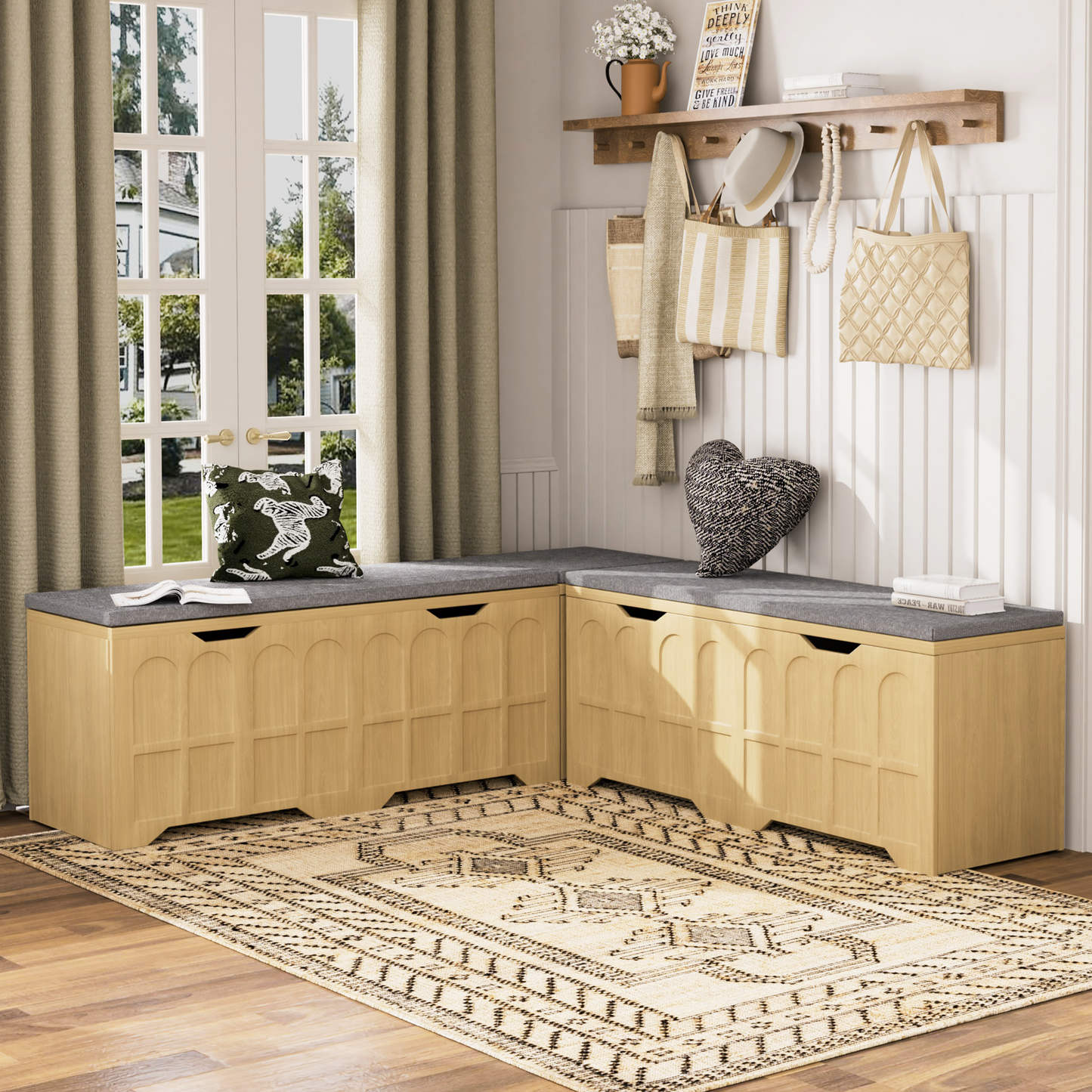 Wooden storage bench with a gray cushion in a room with a window and decorative items.