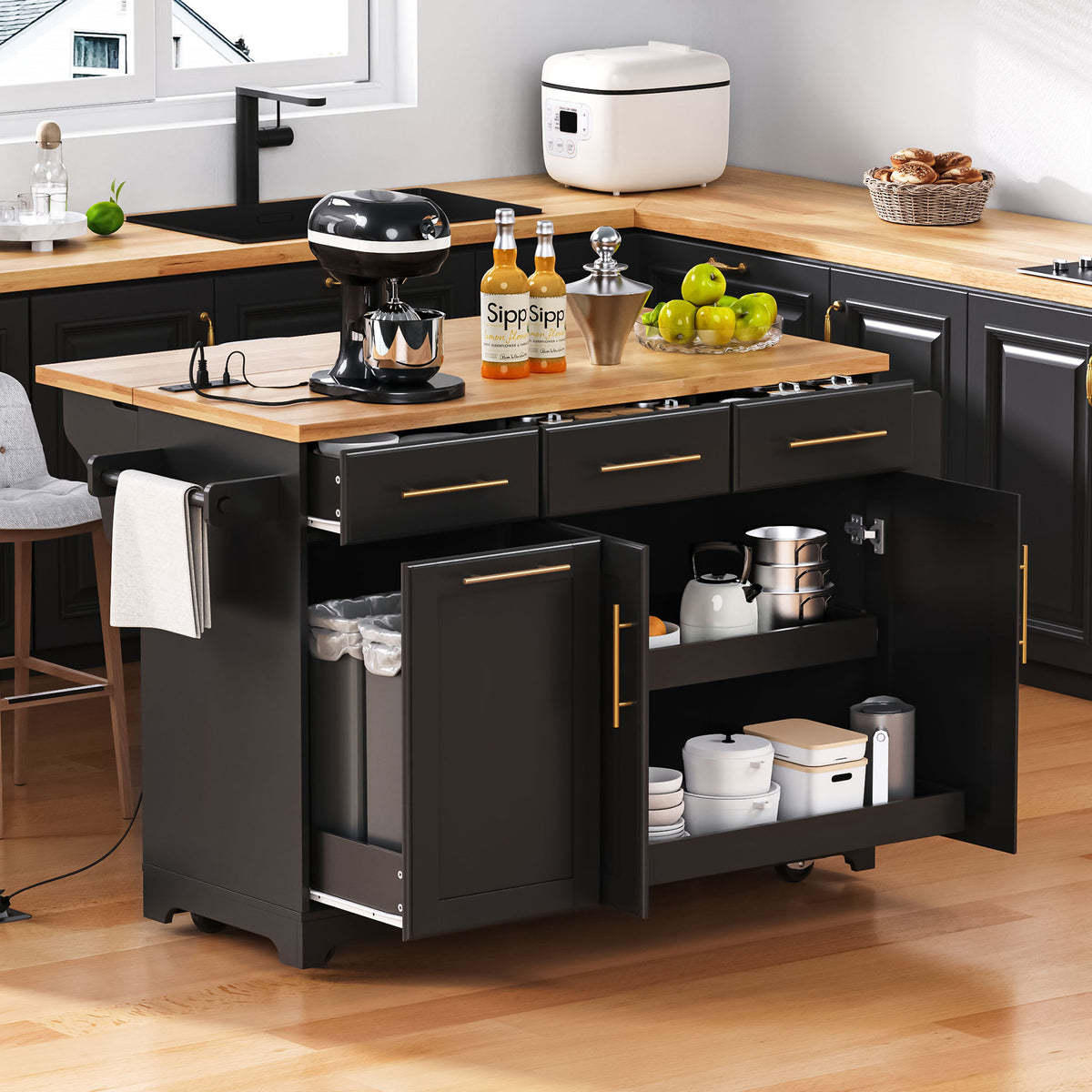 Black kitchen island with open pull-out storage, cookware, and a pale countertop in a black-and-white kitchen.